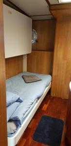 a bed in a small room with a cabinet at M/S Furusund in Furusund