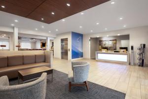 a lobby with couches and chairs in a building at Holiday Inn Express Hotel & Suites Kennesaw Northwest - Acworth, an IHG Hotel in Acworth