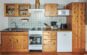 a kitchen with wooden cabinets and a white stove top oven at Beautiful Apartment In Klein St, Paul With 2 Bedrooms in Eberstein