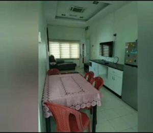 cocina con mesa y sillas en una habitación en HOMESTAY PETRON CABANG 3, en Pengkalan Cepa