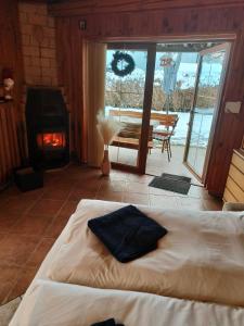 a bedroom with a bed with a fireplace and a table at Kranio in Karlovy Vary