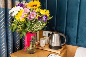 a vase filled with flowers sitting on a table at Kumru Hotel in Istanbul