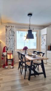 a dining room with a table and chairs in a kitchen at Arctic Circle Home in Rovaniemi