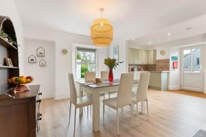 a kitchen and dining room with a table and chairs at Delightful Family Getaway Cornwall in Mawnan Smith