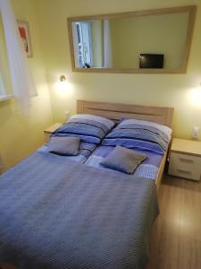 a bedroom with a bed with two pillows on it at APARTAMENT WŁODEK in Jelenia Góra