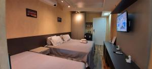 Un pat sau paturi într-o cameră la Apartamento Mania Terceiro Andar
