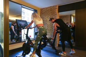 a man and a woman on an exercise bike in a gym at InterContinental New York Times Square by IHG in New York