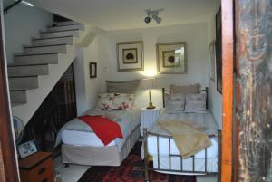 a bedroom with two beds and a staircase at Buckhouse Elegant Village Apartment in Heidelberg
