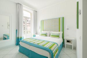 a bedroom with a bed with a colorful headboard at Duomo Guest House in Sorrento