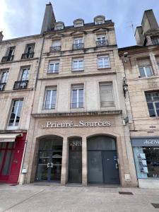 a large stone building with a store at Le Théâtre : Centre historique in Dijon