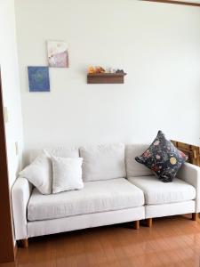 un sofá blanco sentado en una sala de estar en Nobana Mikkabi - Vacation STAY 14751, en Kosai