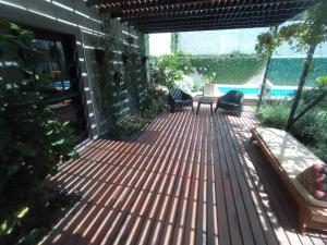 una terraza con sillas y una mesa en una casa en Tres Chihuahuas & Spa en Mariano Moreno