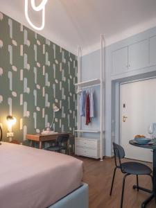 1 dormitorio con 1 cama, mesa y sillas en Mini suite di design, en Milán