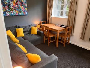 a living room with a couch and a table at Green Cottage in grounds of Grade II* Frognal Farmhouse in Sittingbourne