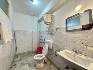 a bathroom with a toilet and a sink at Hotel Norling SK Groups in Pelling +38 photos