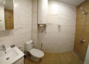 a bathroom with a toilet and a sink and a shower at Витски in Ruse +4 photos