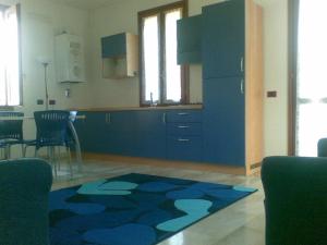a kitchen with blue cabinets and a blue rug at RESIDENCE LA VECCHIA REGGIO in Reggio Emilia