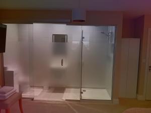 a shower with a glass door in a bathroom at White Quarry House in Navan