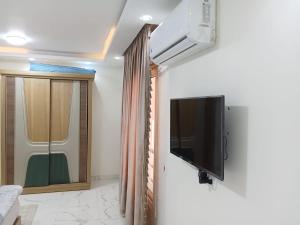 a living room with a flat screen tv on a wall at The perfect stay in Cairo al muhandesin Nile luxury apartment in Cairo