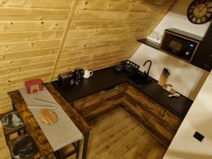 an overhead view of a kitchen in a tiny house at Gorska bajka - Borovica, planinska kuća za odmor i wellness in Stara Sušica