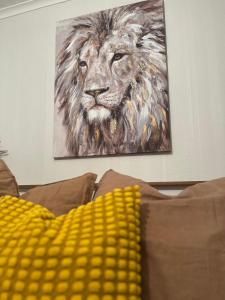 a painting of a lion on top of a couch at The Chroma Cottage in Cock Hill