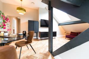 a living room with a table and a couch at The Sky Lodge & Penthouse Apartments at Hillthorpe Manor by Maison Parfaite - Wentbridge in East Hardwick