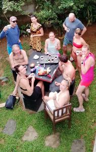 a group of people sitting around a picnic table at The ED Corner - Hiriketiya in Dickwella