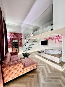 a living room with a couch and a sink at ENZO CAPO Opera Suite in Budapest
