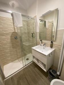 a bathroom with a white sink and a shower at Domus Cinecittà in Rome