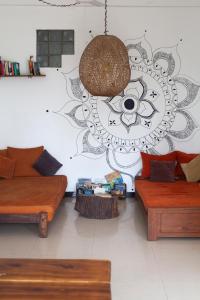 a living room with two couches and a drawing on the wall at Marshmallow Homestay in Ahangama