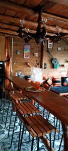 a wooden table and chairs in a room at Los diablitos in Punta Del Diablo