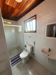 a bathroom with a toilet and a sink at By Búzios Loft in Búzios
