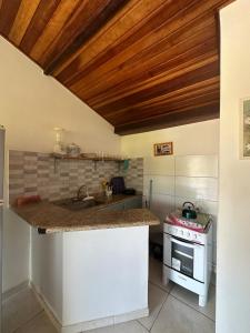 a kitchen with a counter and a stove at By Búzios Loft in Búzios +32 photos
