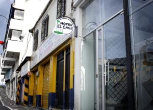 a store with yellow doors and a sign on a building at Hotel el Cable Centro de Pereira in Pereira