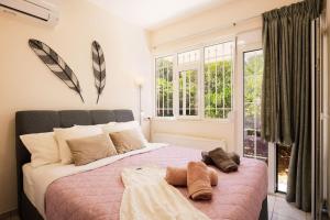 a bedroom with a large bed and a window at Olive Garden Residence in Platanes +60 photos
