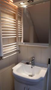 a bathroom with a white sink and a mirror at MiRo Skadarlija Apartment in Belgrade