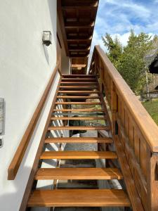 a staircase leading up to a house with wooden railings at Casa con vista a San Vito di Cadore in San Vito di Cadore