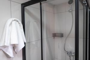 a bathroom with a shower with a white towel at Adore Datca Beach House in Döşeme