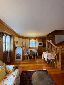 a living room with a bed and a table at Chalet Panorama Dolomiti in San Vito di Cadore