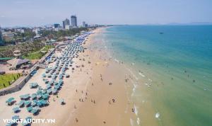 an overhead view of a beach with people and umbrellas at The Song VT Beach Apartment in Vung Tau