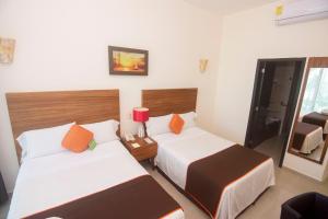Postel nebo postele na pokoji v ubytování Playa Caracol Hotel & Spa