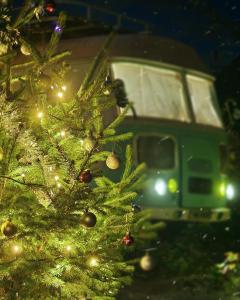 a christmas tree with a train in the background at Pavlove Tiny Bus House in Qabala in Gabala