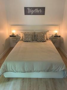 sypialnia z dużym łóżkiem i 2 szafkami nocnymi w obiekcie Owl Cabin - Cozy Forest Retreat nearby Lake w mieście East Kemptville