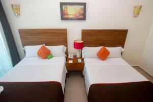 Postel nebo postele na pokoji v ubytování Playa Caracol Hotel & Spa
