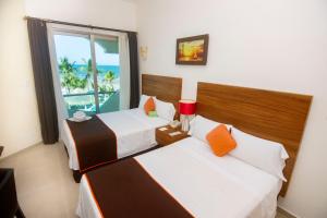Postel nebo postele na pokoji v ubytování Playa Caracol Hotel & Spa