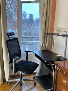 a desk and chair in a room with a window at Stockholm City Room for digital Nomads Elegance & Comfort - Tryggt & Privat - Room3 in Täby
