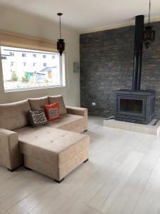 a living room with a couch and a fireplace at CUNCUMEN Caviahue in Caviahue