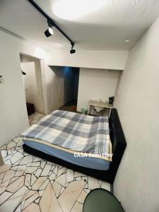 a bedroom with a bed in a room at CASA Homestay in Batu Pahat