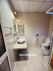 a bathroom with a sink and a toilet at CASA Homestay in Batu Pahat +33 photos