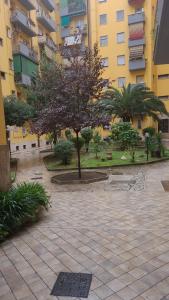 a courtyard with trees in front of a building at Domus Cinecittà in Rome